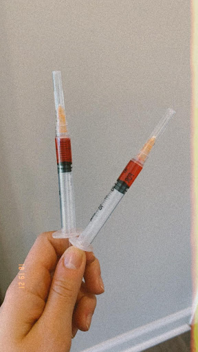 two injections filled with red liquid