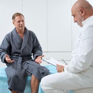 Patient sits on the couch at the reception in clinic